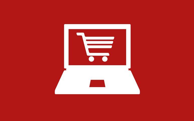Ein weißer Laptop mit einem Einkaufswagensymbol auf rotem Hintergrund symbolisiert Online-Shopping im Webshop.